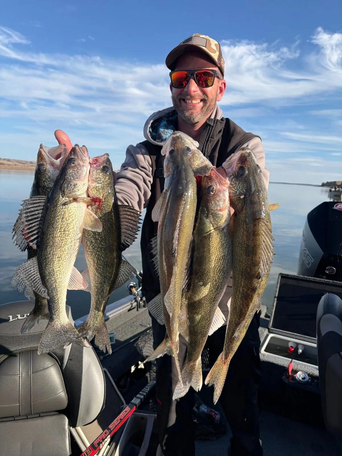 Angler holding several walleye on a Legendary Outdoors trip
