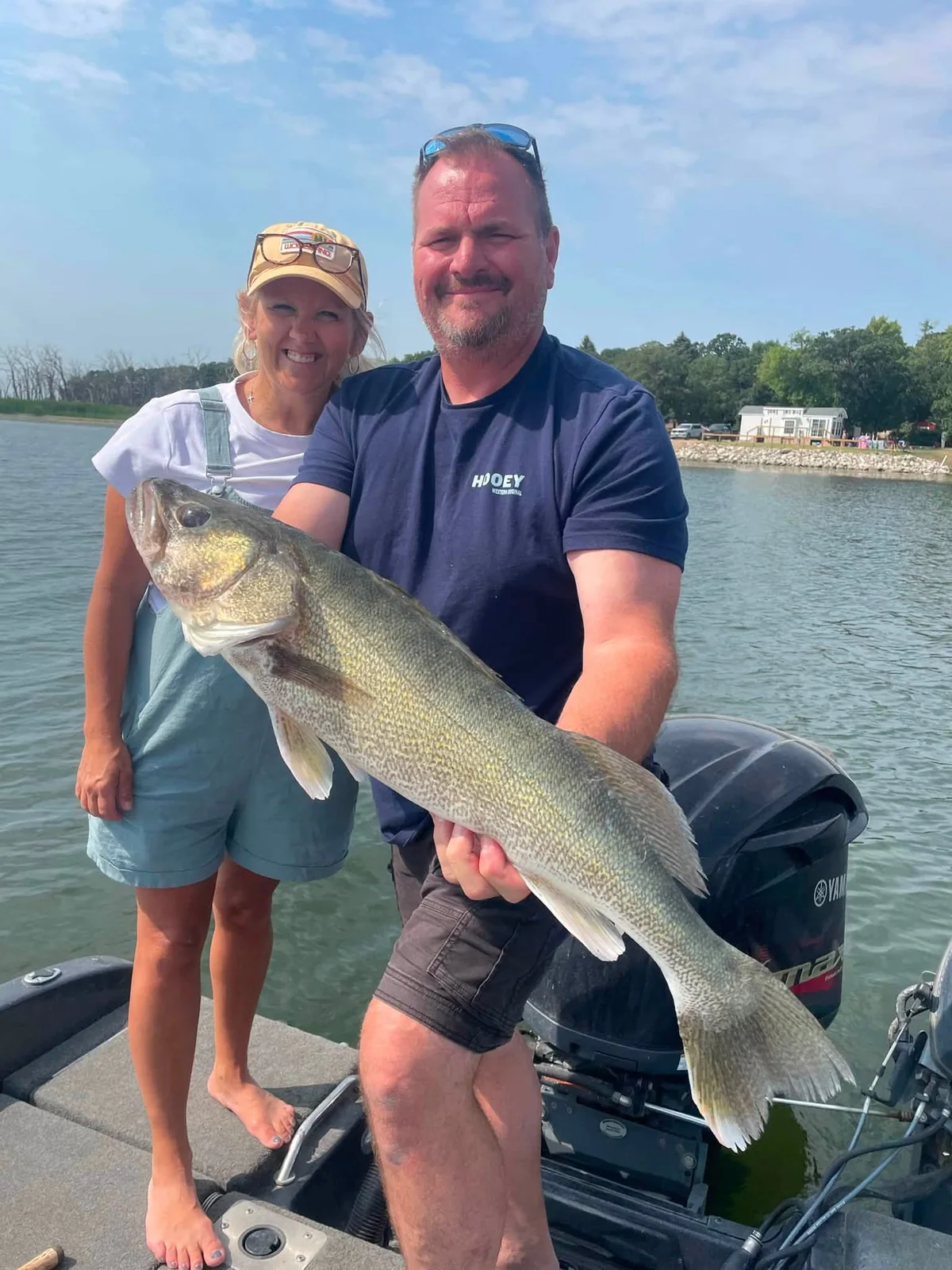 Fishing guests displaying a large walleye