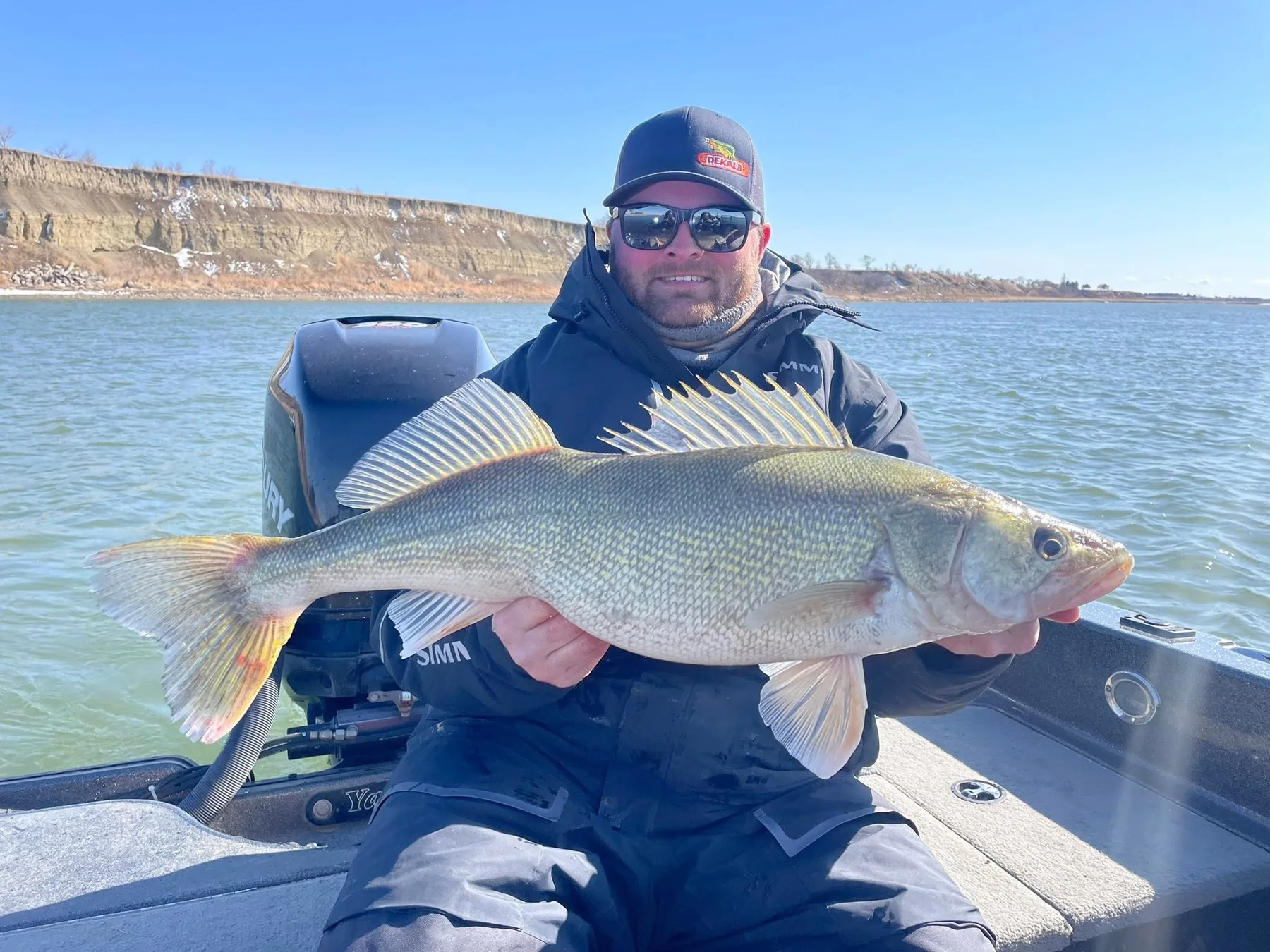 Angler holding a large walleye on North Dakota water
